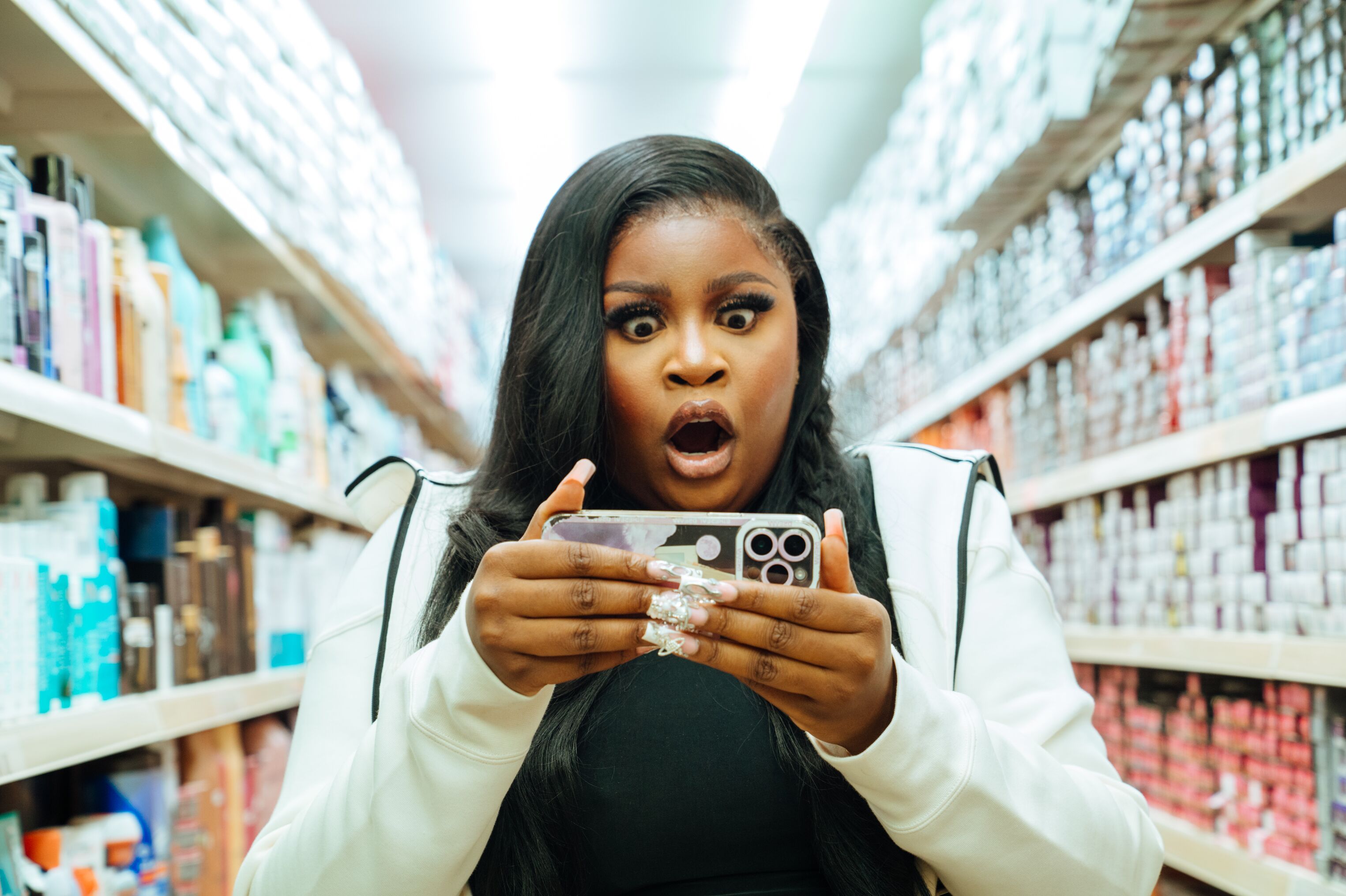 Woman looking at a mobile phone in a library